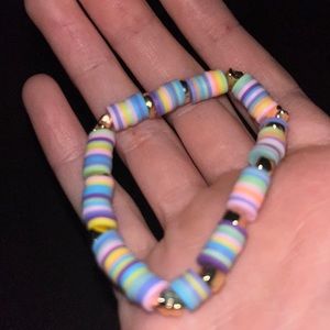 A gold star and gold square colorful bracelet